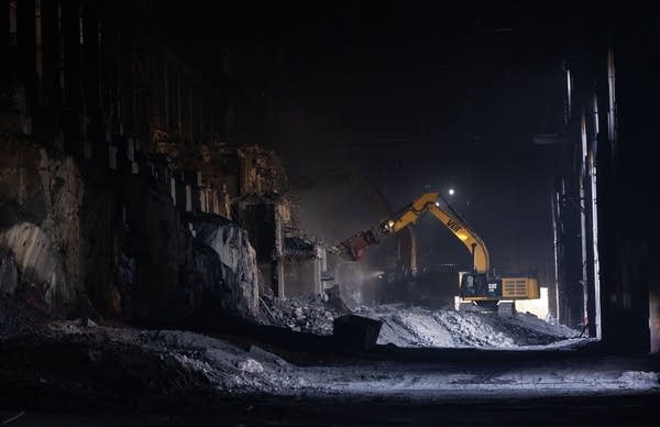 a bulldozer works on a structure