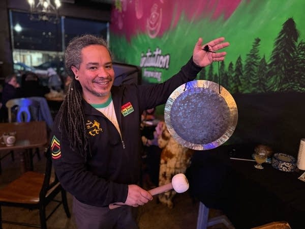 person posing with a gong