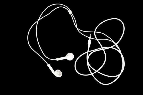 Earbuds on a black background