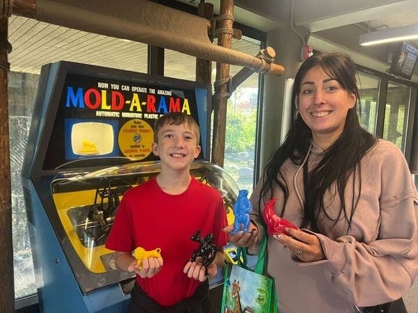 Mom and son hold toys