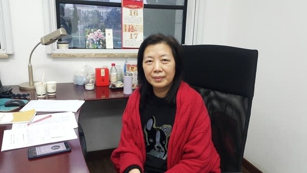 Social credit expert Hu Naihong sits in her office.