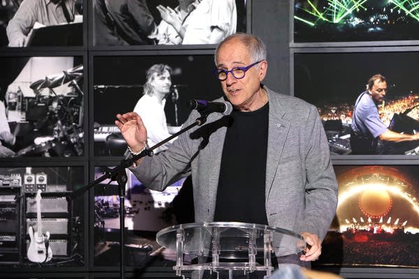 A man speaks at a press conference about a music exhibit