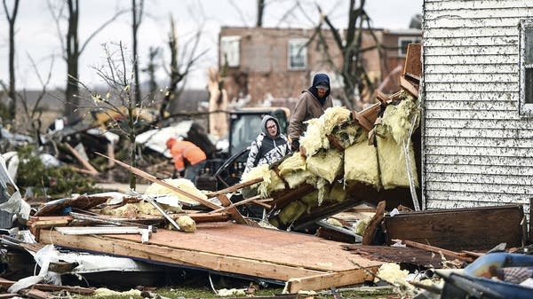 People look at damage left by a tornado