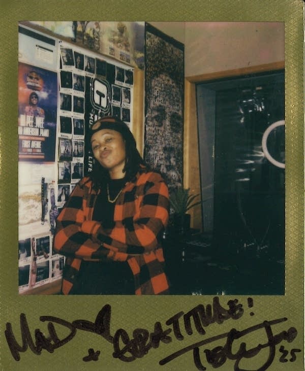 Tish Jones posing for a polaroid photo
