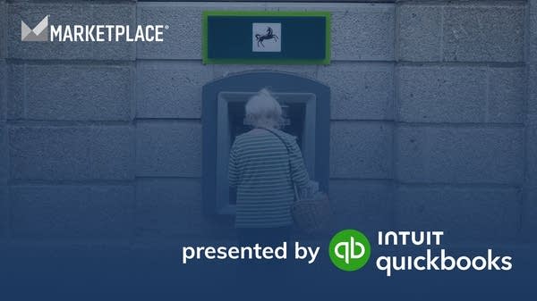 An older woman uses an ATM