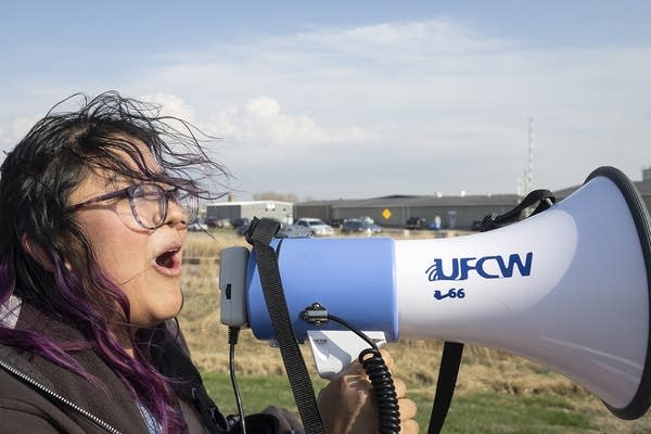 A person chants into a microphone 