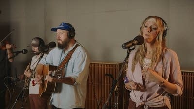 Four musicians performing in a recording studio