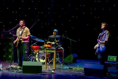 Three people performing on stage