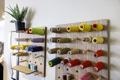 Fabrics and sewing threads are displayed