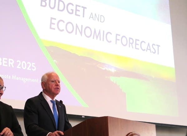 People speak at a podium