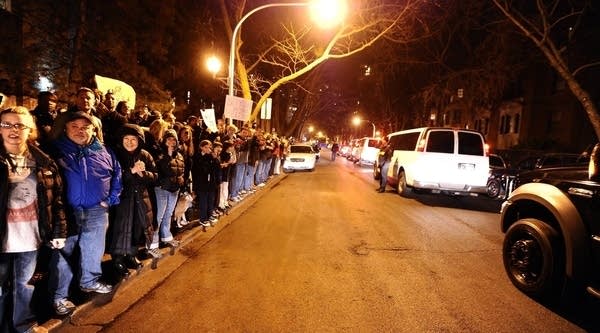 People crowd the sidewalk outside a house where US President Barack Obama stopped for a campaign event in Chicago, Ill., on January 11, 2012. 
