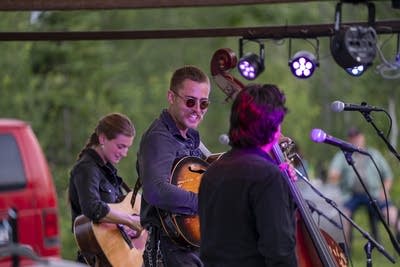 the band wild horses performing on an outdoor stage