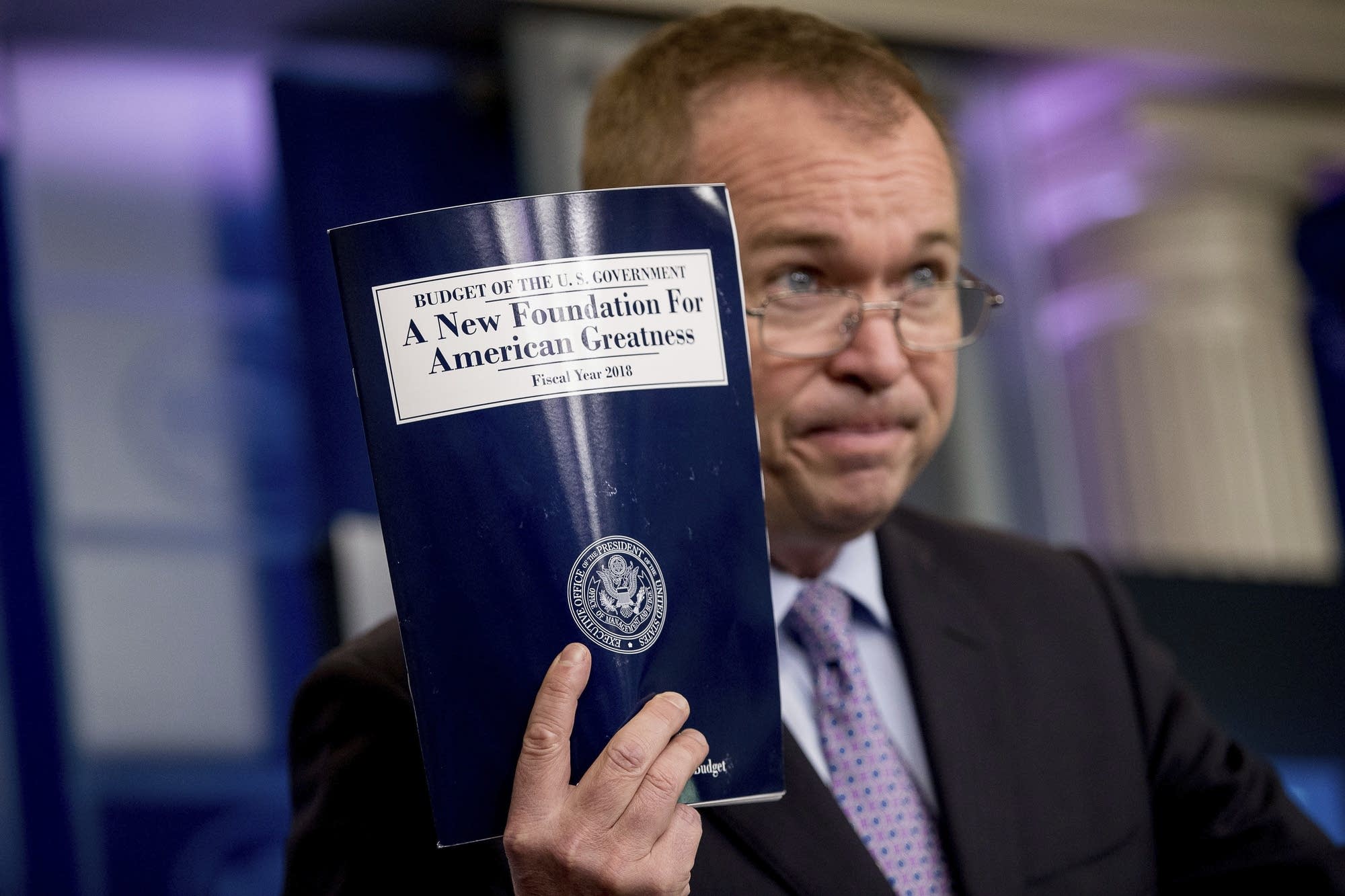 Budget Director Mick Mulvaney holds up a copy of proposed budget.