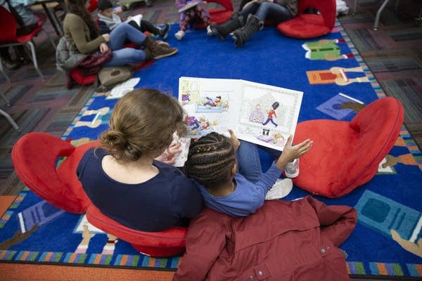 Book Buddies volunteer Emily McPhillips reads with a first grader.