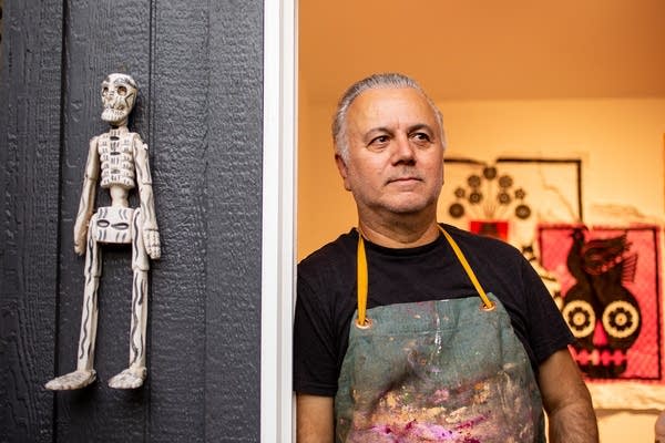 A man poses next to a wall