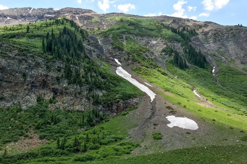 Slivers of snow still hide in coulees near Schofield Pass.