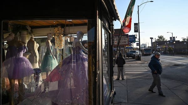 Above, pedestrians walk outside a dress shop in Chicago's Little Village neighborhood, dubbed the “Mexico of the Midwest."