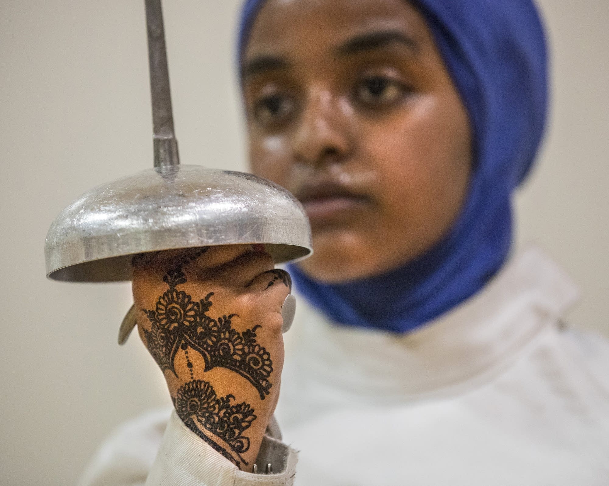 Displaying vivid henna art, Ekhlas Abdullahi watches others spar.