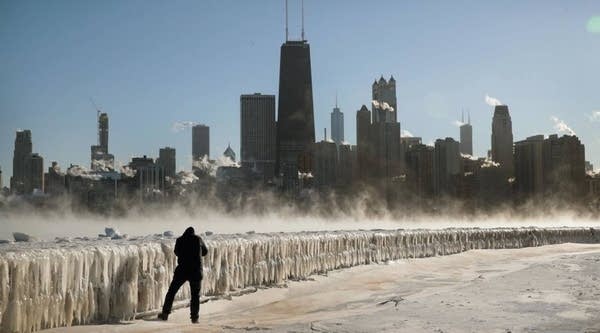 A man takes a picture along the lakefront as temperatures hovered around -20 degrees on January 30, 2019 in Chicago, Illinois.