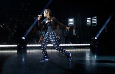 A woman sings onstage