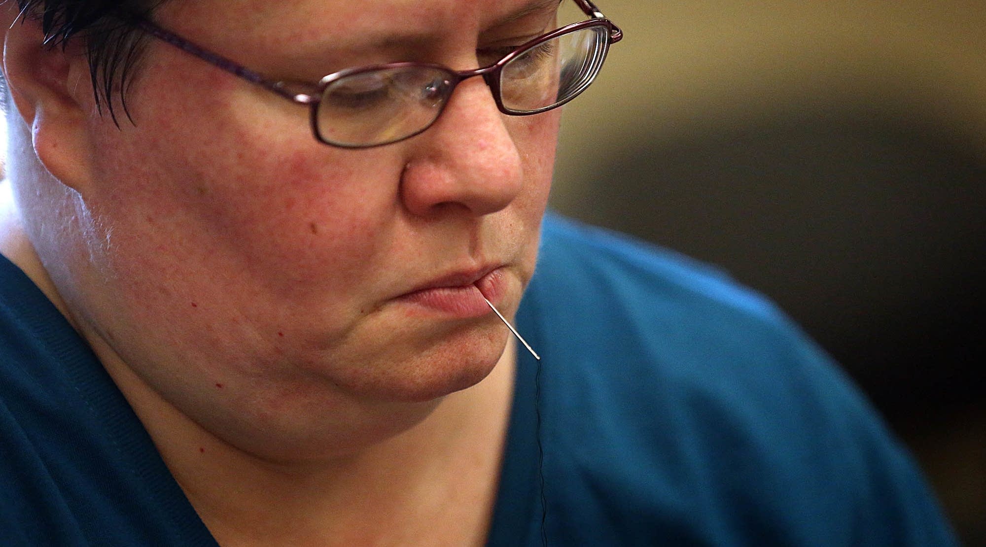Michelle Ooley keeps hands free while working on clothing for mending.