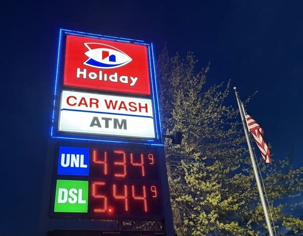 A gas station price shows a gallon of gas at $4.34