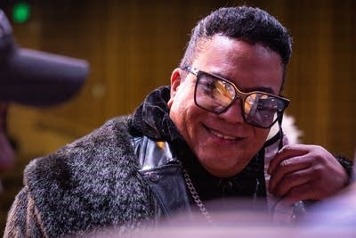 A piano is reflected in a man's sunglasses