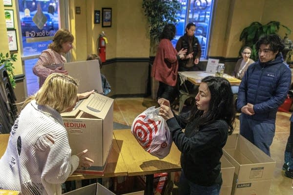 People gather aid packages