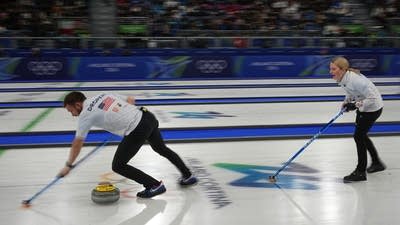 Two curlers compete in a match