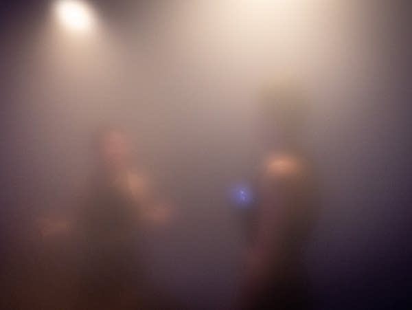 Steam obscures the figures of two people