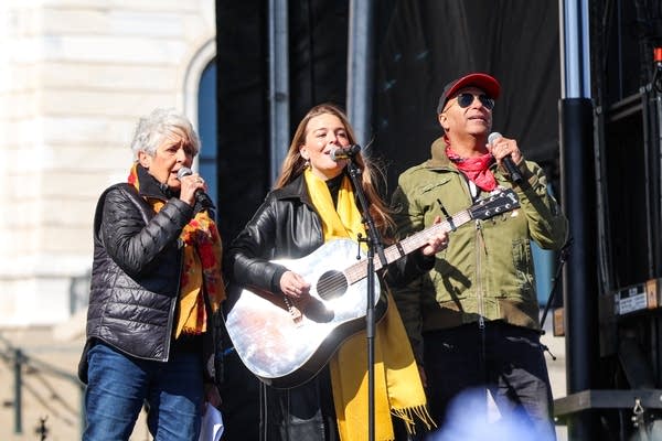 Three people perform together 