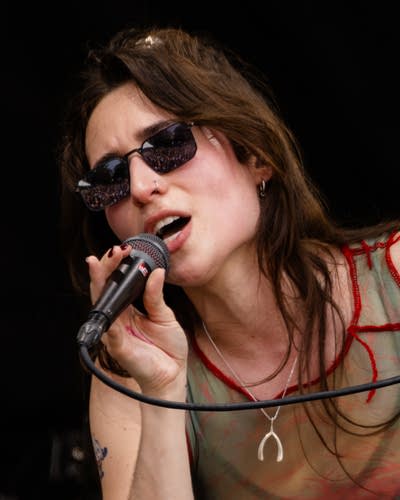Couch performing on an outdoor stage.