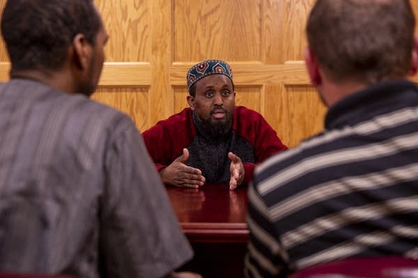 Imam Mohamed Omar speaks to Abdulahi Farah and Zavier Bicott.