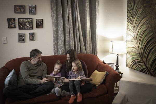 family reads book together