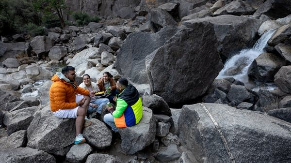 People picnic on rocks in Yosemite.