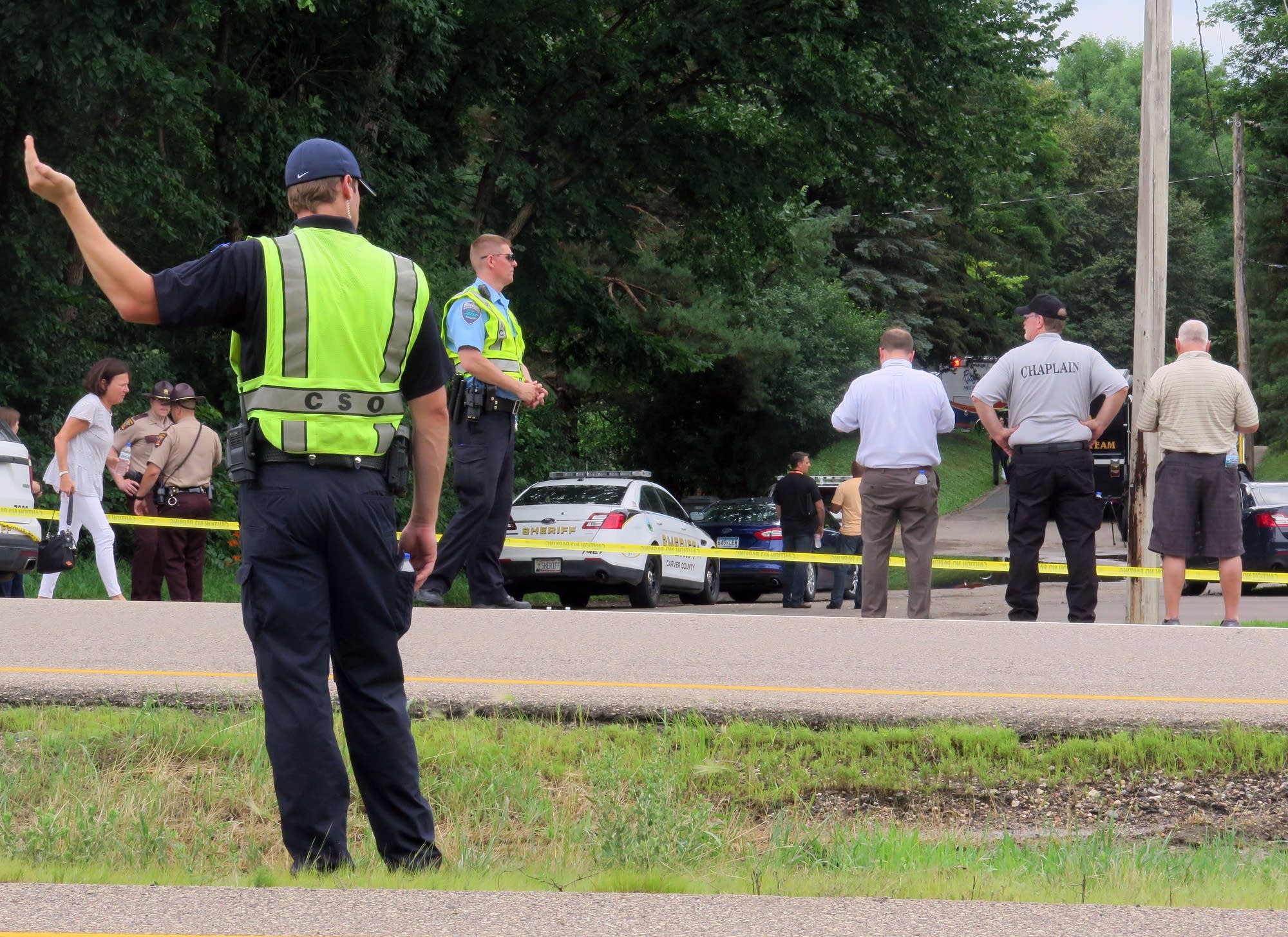 A policeman directs traffic along Hwy. 7 near the scene of a shooting.