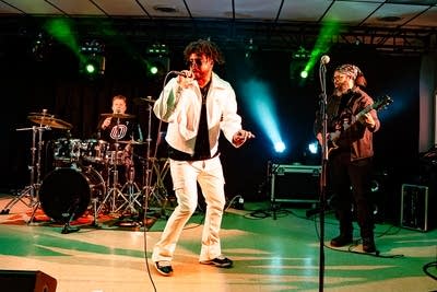 A four-piece band performing onstage