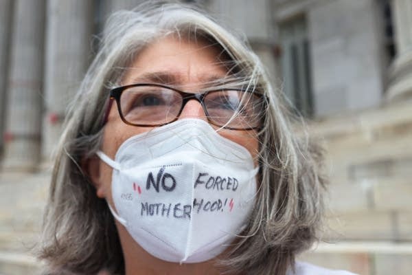 NEW YORK, NEW YORK - SEPTEMBER 01: Debra Sweet, wears a mask inscribed with the words " No Forced Motherhood" as she joins people gathered for a reproductive rights rally at Brooklyn Borough Hall on September 01, 2021 in Downtown Brooklyn in New York City. NOW-NYC and Planned Parenthood of Greater New York Action Fund organized a rally for reproductive rights after a Texas law that has been dubbed the "Heartbeat Bill" went into effect. The law ends access to abortion after six weeks of pregnancy and would allow anyone to sue abortion providers and “aiders and abetters” in civil court. Abortion rights activists have asked the Supreme Court to block the law, but as of Wednesday morning the court has allowed the law to go into effect. In May, Supreme Court justices agreed to review a Mississippi case on the state's ban on abortion procedures after 15 weeks of pregnancy,  a direct challenge to Roe v. Wade, the 1973 landmark decision that legalized abortion nationwide. A ruling on that case is expected in 2022.  