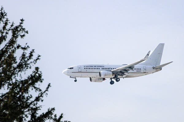 A plane descends from the sky.