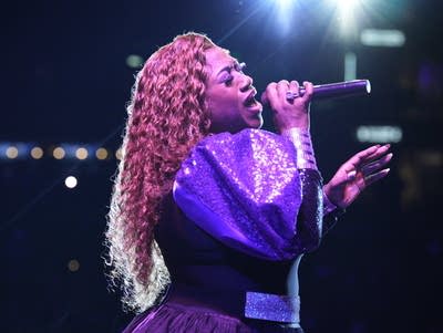 Jamecia Bennett sings into a microphone.