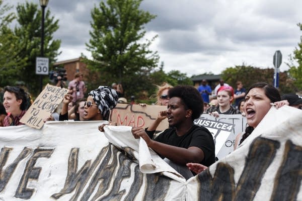 Protesters sit on the street in St. Anthony, chanting 'Black lives matter.'