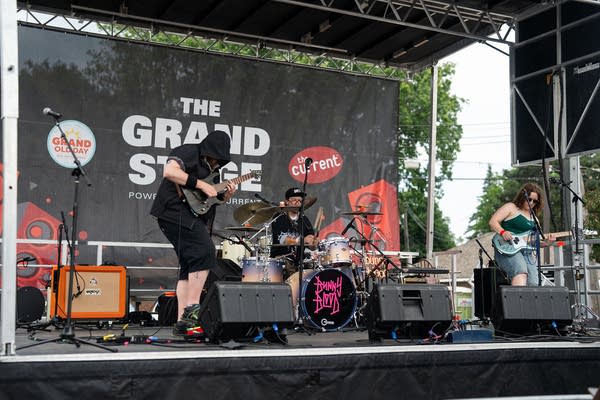 A band performing on an outdoor stage