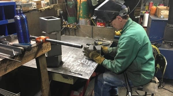 Dave Karki welds an "airbox" for Lamppa Manufacturing's EPA-approved wood-burning furnace.
