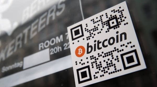 A sticker on the window of a local pub indicates the acceptance of Bitcoins for payment in Berlin, Germany.