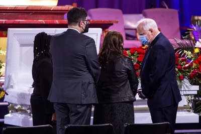 Gov. Tim Walz, right, pays his respects during the funeral 