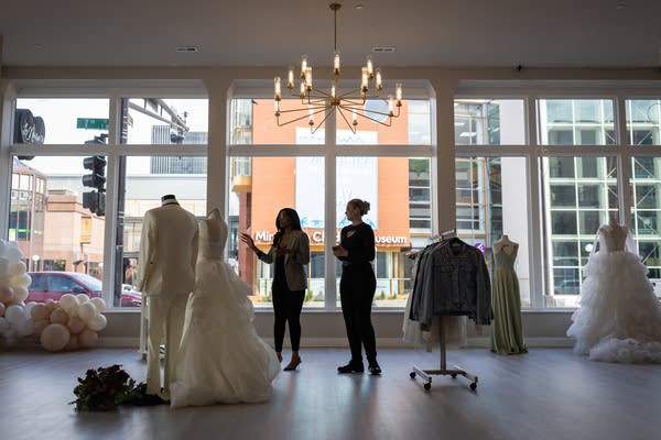 Two women work in a bridal shop