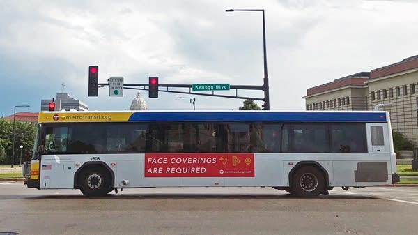 An ad on a Metro Transit bus says masks are required to get on buses. 