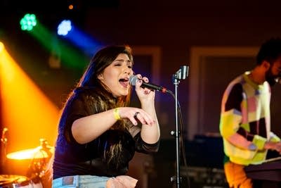 Woman singing and dancing on stage