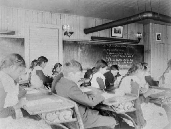 A black and white photo of students in a classroom circa 1990.