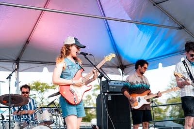 A band performing on an outdoor stage